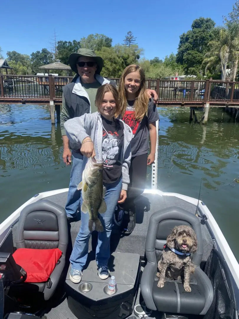 Family fishing with a large bass.