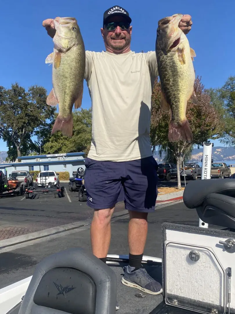 Angler holding two large bass.