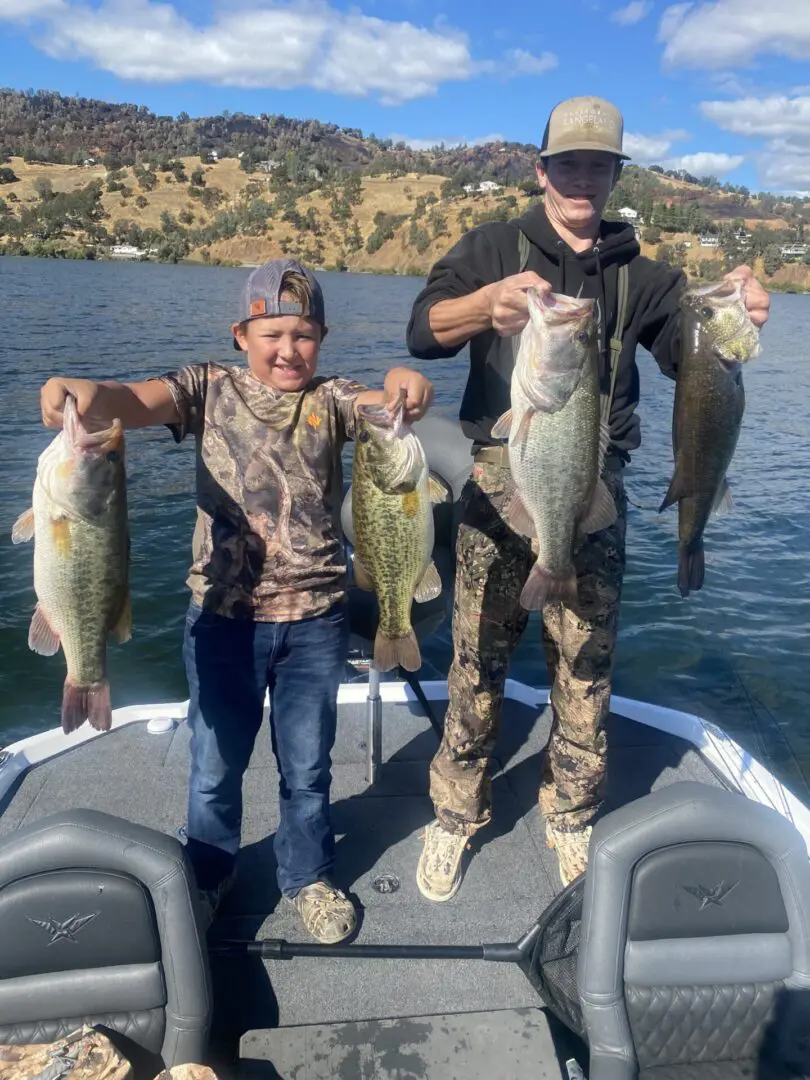 Two boys proudly display their bass catch.