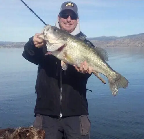 Man holding a large bass fish.