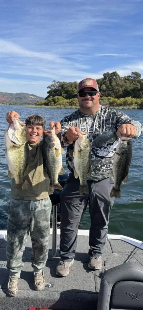 Two anglers with four large bass.